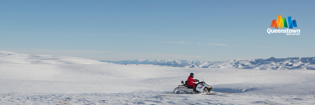 person snowmobiling in new zealand
